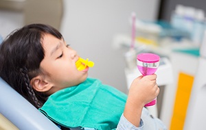 Child with fluoride treatment in mouth