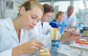 A female technician working on dentures