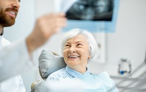 A smiling elderly woman getting a dental checkup