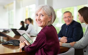 A senior businesswoman working in a conference room