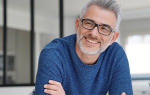 Man smiling after getting dentures