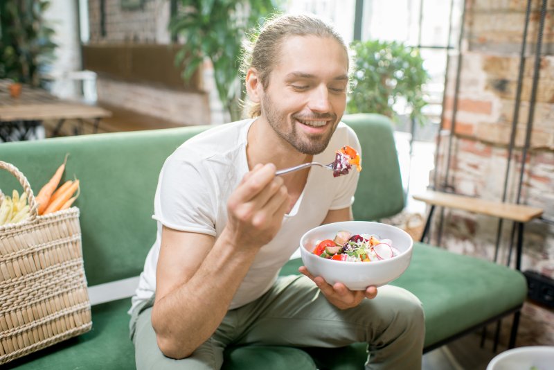 Patient eating after wisdom tooth extractions